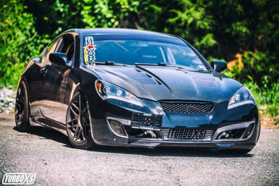 Turbo XS 09-14 Hyundai Genesis Coupe License Plate Relocation Kit installed on black high-performance car