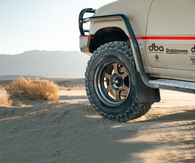 Off-road vehicle on desert terrain with high-performance brake systems and suspension kits for enhanced stability.