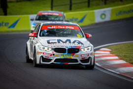 Performance race car on track with branding