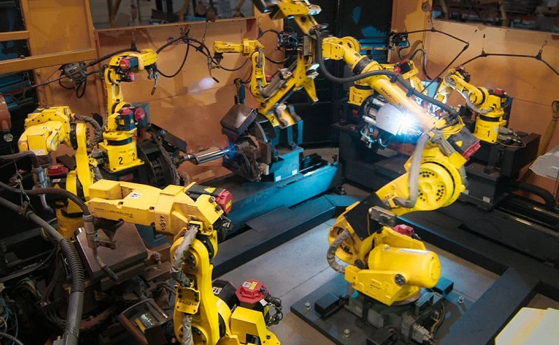 Industrial robotic arms assembling in factory