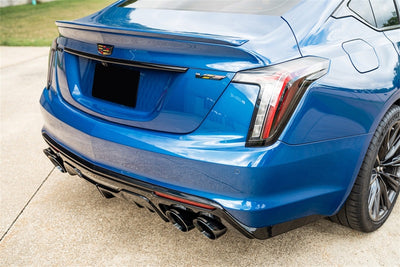 Corsa 22-25 Caddy CT5-V Blackwing 3in Axle-Back exhaust system on blue Cadillac, high performance auto parts upgrade.