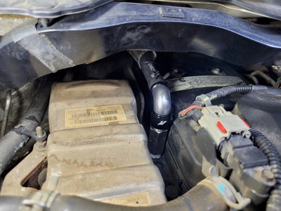 Mishimoto 2007.5+ Ram 6.7L Cummins Top Heater Hose Upgrade installed in engine bay, boosting reliability for performance car parts.