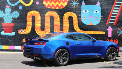Blue Chevrolet Camaro with Corsa 2017-2024 Chevrolet Camaro SS 6.2L V8 2.75in Polished Xtreme Axle-Back Exhaust in urban setting