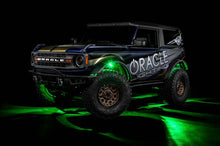 Load image into Gallery viewer, Oracle Underbody RGB+W Wheel Well Rock Light Kit showcasing green LED lighting under a rugged vehicle for performance upgrades.