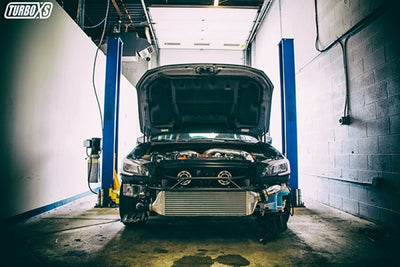 Turbo XS FMIC 2015-2017 Subaru STi - Wrinkle Black Pipes install in garage