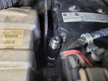 Load image into Gallery viewer, Mishimoto 2007.5+ Ram 6.7L Cummins Top Heater Hose Upgrade installed in engine bay, enhancing reliability and performance.