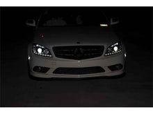 Load image into Gallery viewer, Spyder Mercedes Benz C-Class 08-11 Projector Headlights Halogen - DRL Blk installed on a vehicle at night, enhancing visibility.