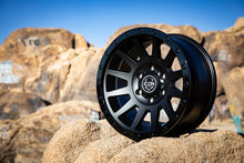 Load image into Gallery viewer, ICON Compression 17x8.5 6x5.5 25mm Offset 5.75in BS 95.1mm Bore Double Black Wheel on rocky landscape