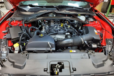 JLT 15-19 Ford Mustang Black Textured Coolant Tank Cover installed in engine bay, performance upgrades by veteran owned shop.
