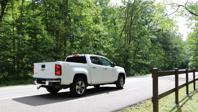 Corsa 2017-22 Chevrolet Colorado on highway with sport cat-back system and black tips for performance upgrades and tuning