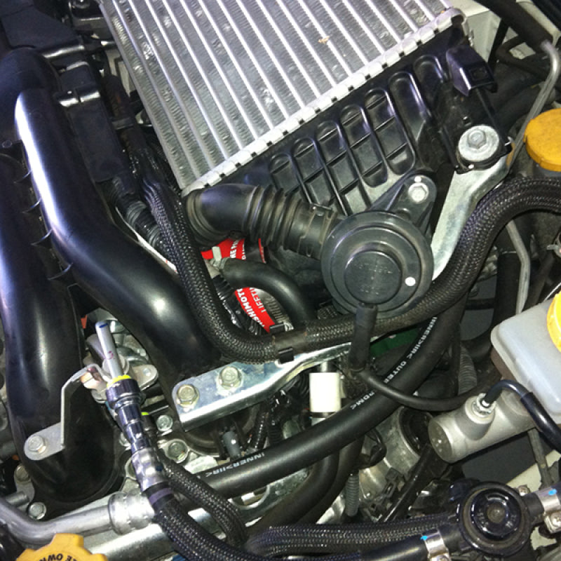 Mishimoto Subaru WRX Black Silicone Throttle Body Hose in Subaru engine bay for performance car parts.