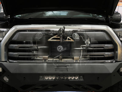 aFe 22-24 Toyota Tundra BladeRunner Transmission Oil Cooler Kit in a vehicle's front grill showcasing performance upgrades and high efficiency.