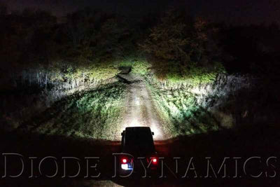 Diode Dynamics SS3 Pro Type FT Kit ABL - Yellow SAE Fog in action at night, highlighting rugged terrain with bright, focused light