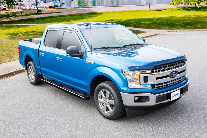Blue truck with running boards parked outdoors