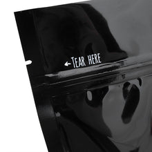 Load image into Gallery viewer, Close-up of a black package with &#39;Tear Here&#39; mark