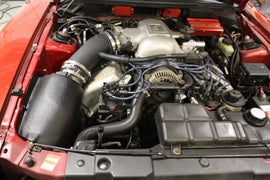 JLT 96-98 Ford Mustang SVT Cobra Black Textured Ram Air Intake Kit w/Red Filter installed engine view