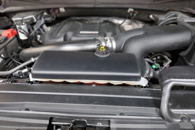 JLT 15-19 Ford F-150/Raptor Black Textured Coolant Tank Cover in engine bay; fits performance car parts from DTX Performance.