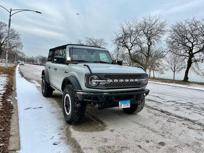 Off-road vehicle parked on snowy road