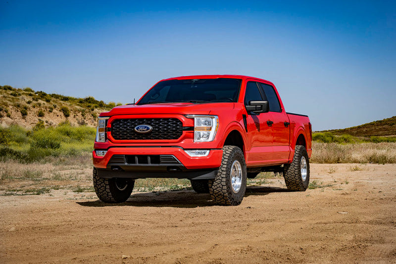 Red Ford F-150 Tremor with ICON 2.5-3in Coilover Kit showcasing performance car parts and aftermarket upgrades.