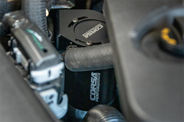 Corsa 2018-2023 Ford Mustang GT 5.0L V8 Oil Catch Can in engine bay, performance car parts by DTX Performance.
