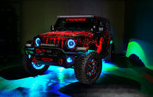 Load image into Gallery viewer, Oracle Bluetooth + RF Underbody Rock Light Kit - 8 PCS - ColorSHIFT on a Jeep with vibrant LED glow, ideal for off-road performance.