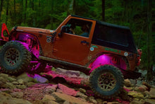 Load image into Gallery viewer, Off-road Jeep with Oracle Bluetooth + RF Underbody Rock Light Kit in action, showcasing ColorSHIFT technology and rugged performance.