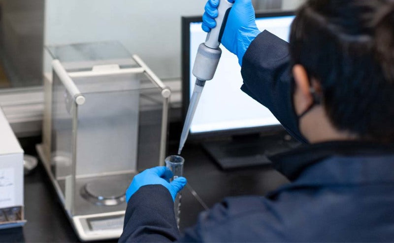 Scientist using a pipette in a lab