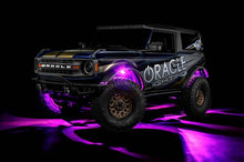 Load image into Gallery viewer, Oracle Underbody RGB+W Wheel Well Rock Light Kit - 4 PCS - ColorSHIFT installed on a vehicle, showcasing vibrant pink glow.