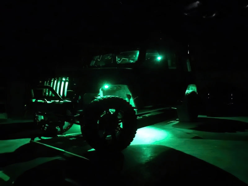 Oracle Bluetooth + RF Underbody Rock Light Kit illuminated on off-road vehicle, showcasing ColorSHIFT technology for performance car tuning.