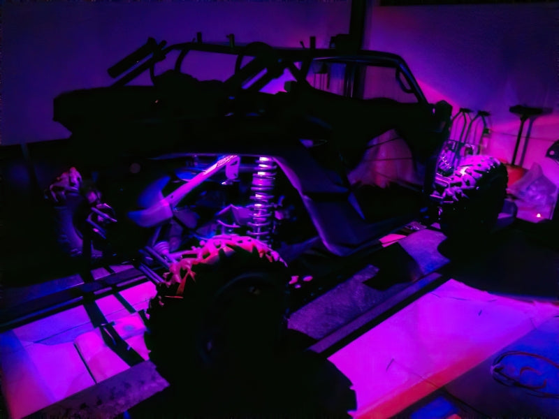 Oracle Bluetooth + RF Underbody Rock Light Kit illuminating 4x4 vehicle, perfect for performance car upgrades and DTX Performance parts.