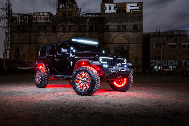 Jeep with Oracle Bluetooth + RF Underbody Rock Light Kit lit up at night for high performance car parts enthusiasts.