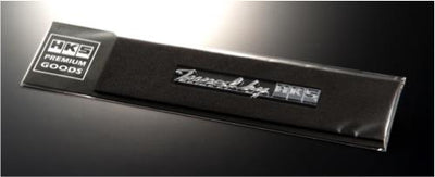HKS HKS EMBLEM tune by HKS on black packaging, performance upgrades by DTX Performance, for engine and exhaust systems.