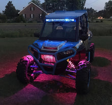 Load image into Gallery viewer, Oracle Bluetooth + RF Underbody Rock Light Kit - 8 PCS - ColorSHIFT installed on off-road vehicle glowing in pink.