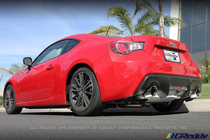 GReddy 13-15 Scion FR-S Supreme SP Exhaust installed on a red sports car, showcasing DTX Performance upgrades and exhaust systems.