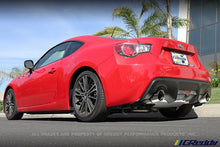 Load image into Gallery viewer, GReddy 13-15 Scion FR-S Supreme SP Exhaust installed on a red sports car, showcasing DTX Performance upgrades and exhaust systems.