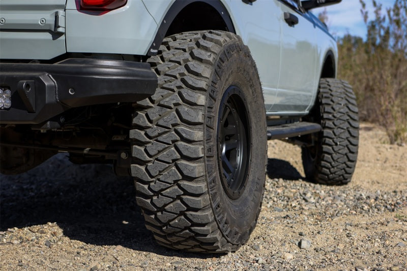 Mickey Thompson Baja Legend MTZ Tire - 35X12.50R17LT on rugged terrain, perfect for performance car parts enthusiasts.
