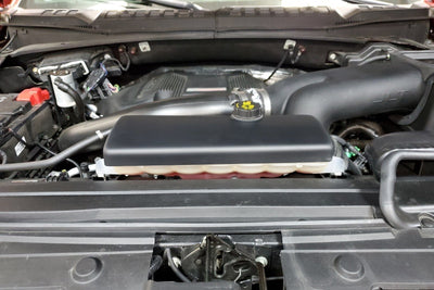 JLT 15-19 Ford F-150/Raptor Black Textured Coolant Tank Cover in engine bay for performance car parts by DTX Performance.