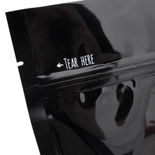 Load image into Gallery viewer, Close-up of &quot;Tear Here&quot; on a black package