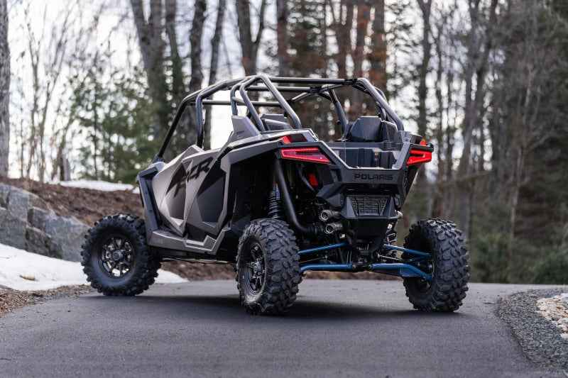 MBRP 20-22 Polaris RZR Pro XP 2.5in Slip-On Active Exhaust Dual Out on rugged terrain, showcasing performance car parts by DTX Performance