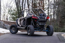 Load image into Gallery viewer, MBRP 20-22 Polaris RZR Pro XP 2.5in Slip-On Active Exhaust Dual Out on rugged terrain, showcasing performance car parts by DTX Performance