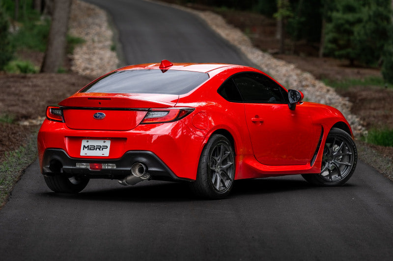 Red sports car with MBRP 12-22 BRZ 17-22 GR86 13-16 FR-S Aluminized Steel 3in Cat-Back-Single Rear Exit on a road.